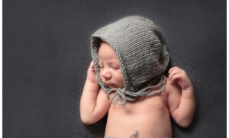 newborn baby boy in bonnet