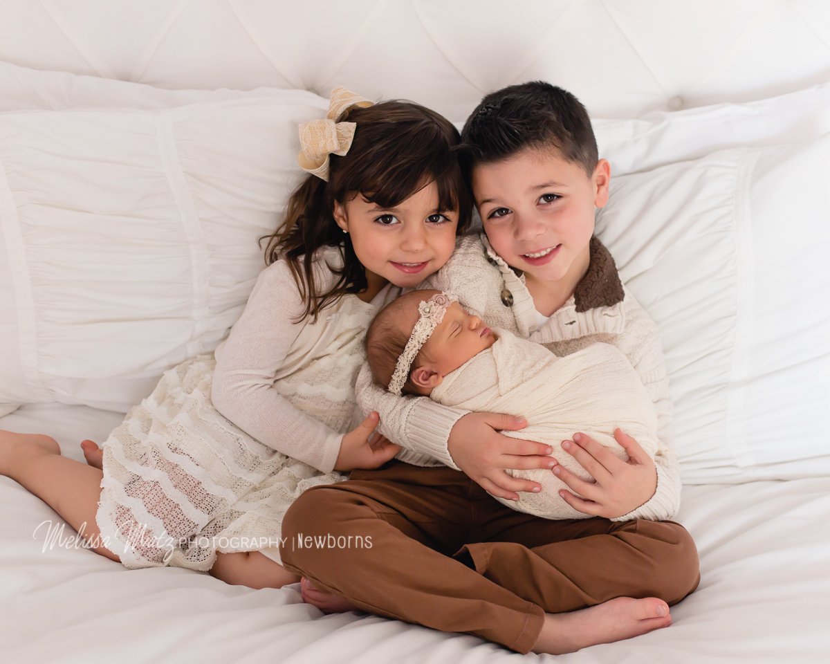 siblings with newborn baby sister newborn photos Oakland Township Mi