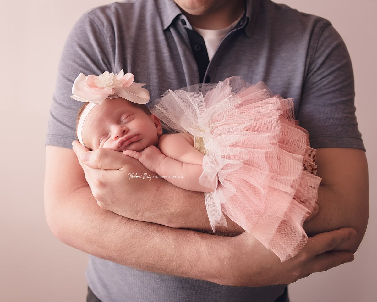 newborn-baby-girl-in-daddys-arms-tutu-macomb-county-newborn-photographer