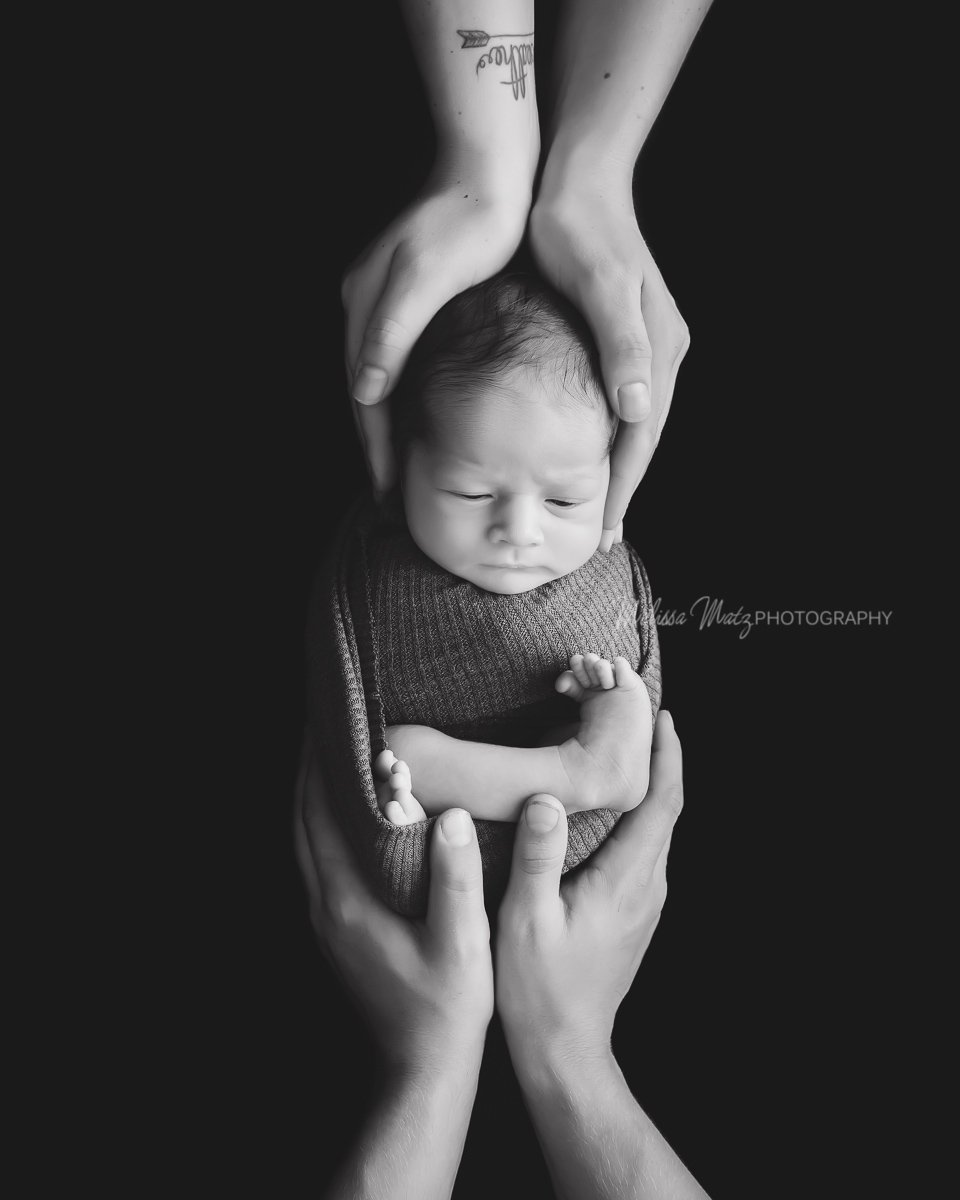 macomb-county-newborn-photographer-newborn-baby-boy-in-parent's-hands