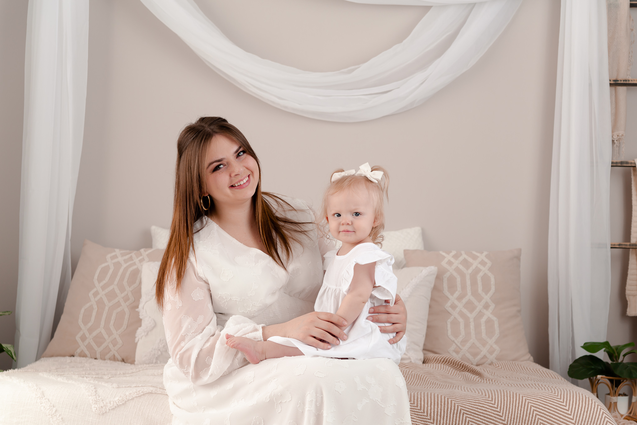 momma and her baby girl dressed in white during their motherhood photo session in macomb county photography studio