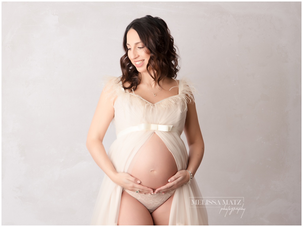 maternity photo in a cream tulle gown done in a shelby township mi photography studio