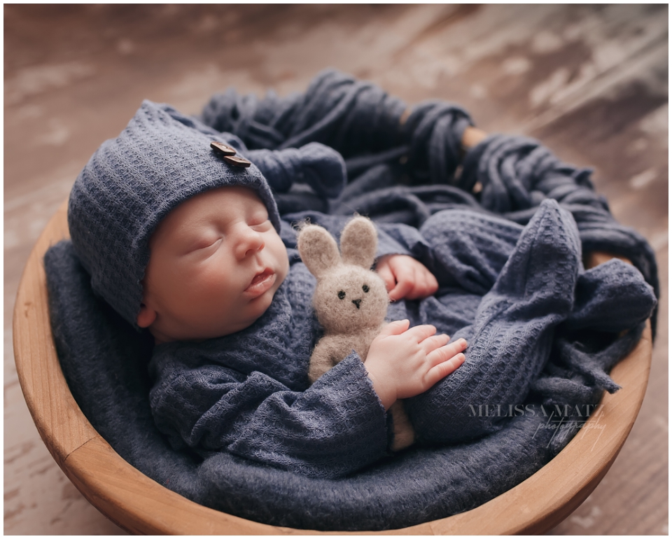 Professional newborn photographer in Shelby Township using creative light setups
