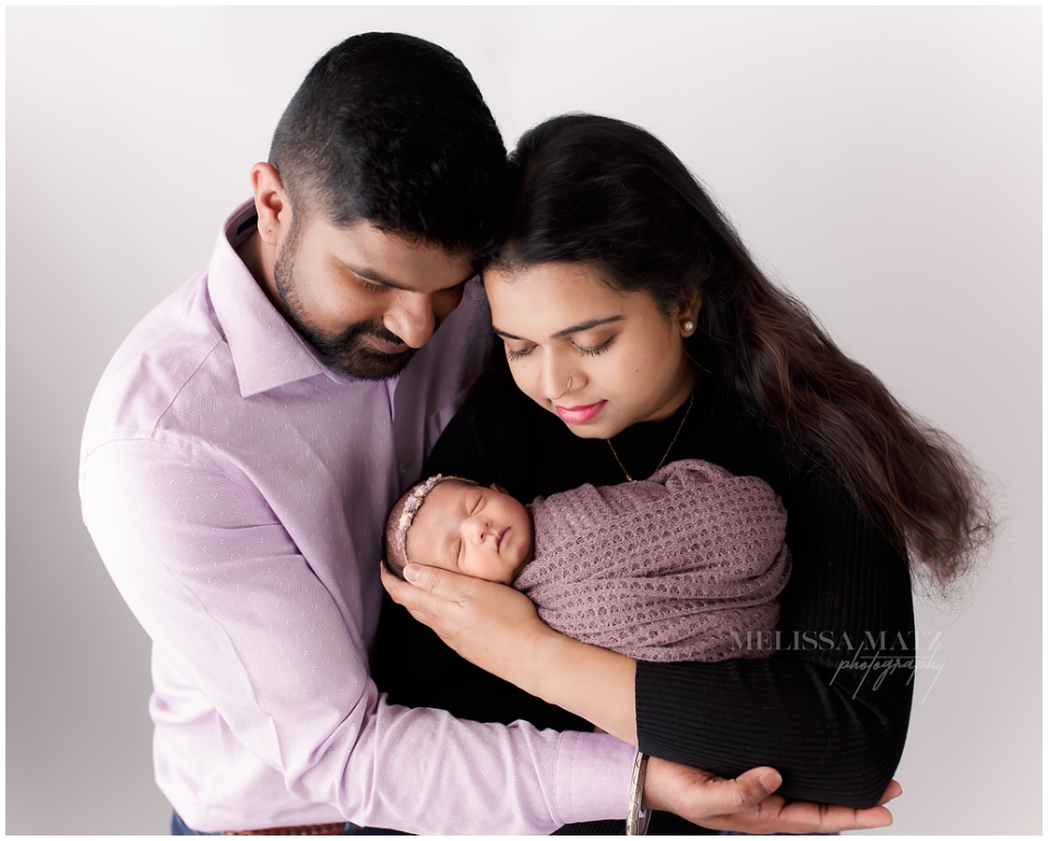 Professional newborn photographer in Shelby Township using creative light setups