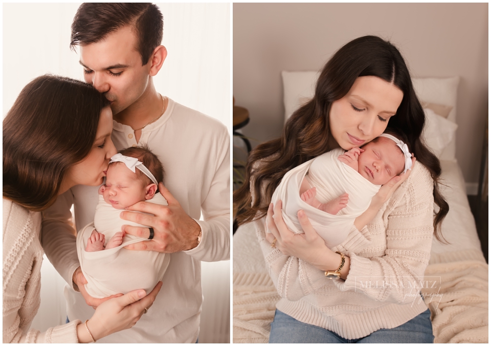 parents holding their newborn baby wrapped in white