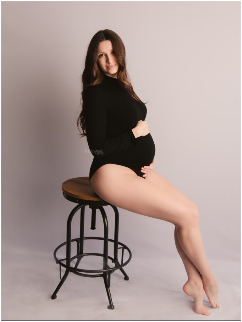 maternity portrait of expecting woman in black bodysuit