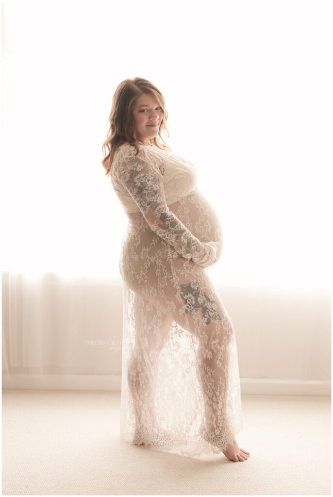 mom to be during her natural light studio maternity session in macomb county mi