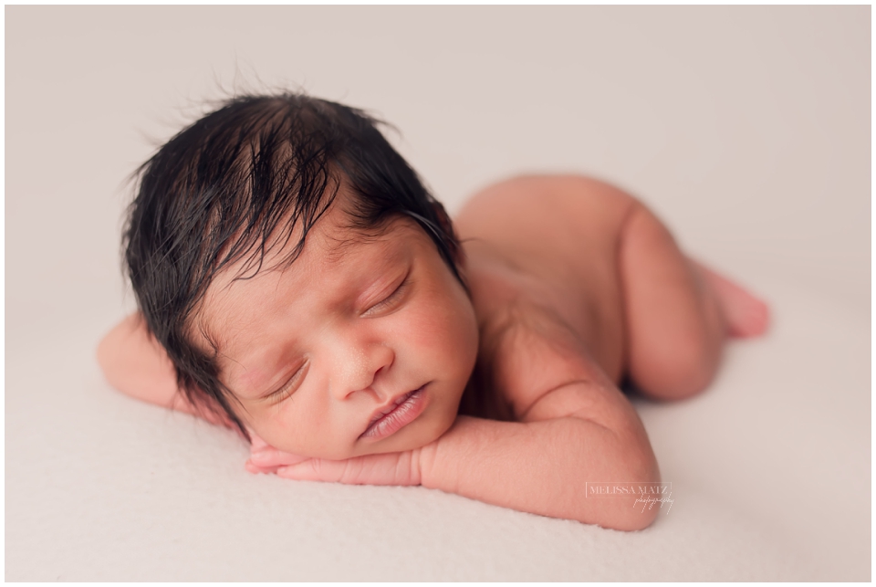 portrait of a sleepy newborn baby during his newborn photo session in metro detroit