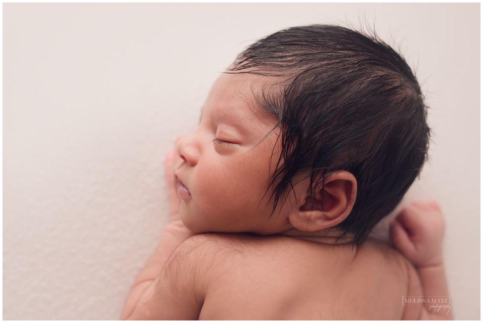 side profile photo of a sleepy newborn baby during his newborn photo session in metro detroit