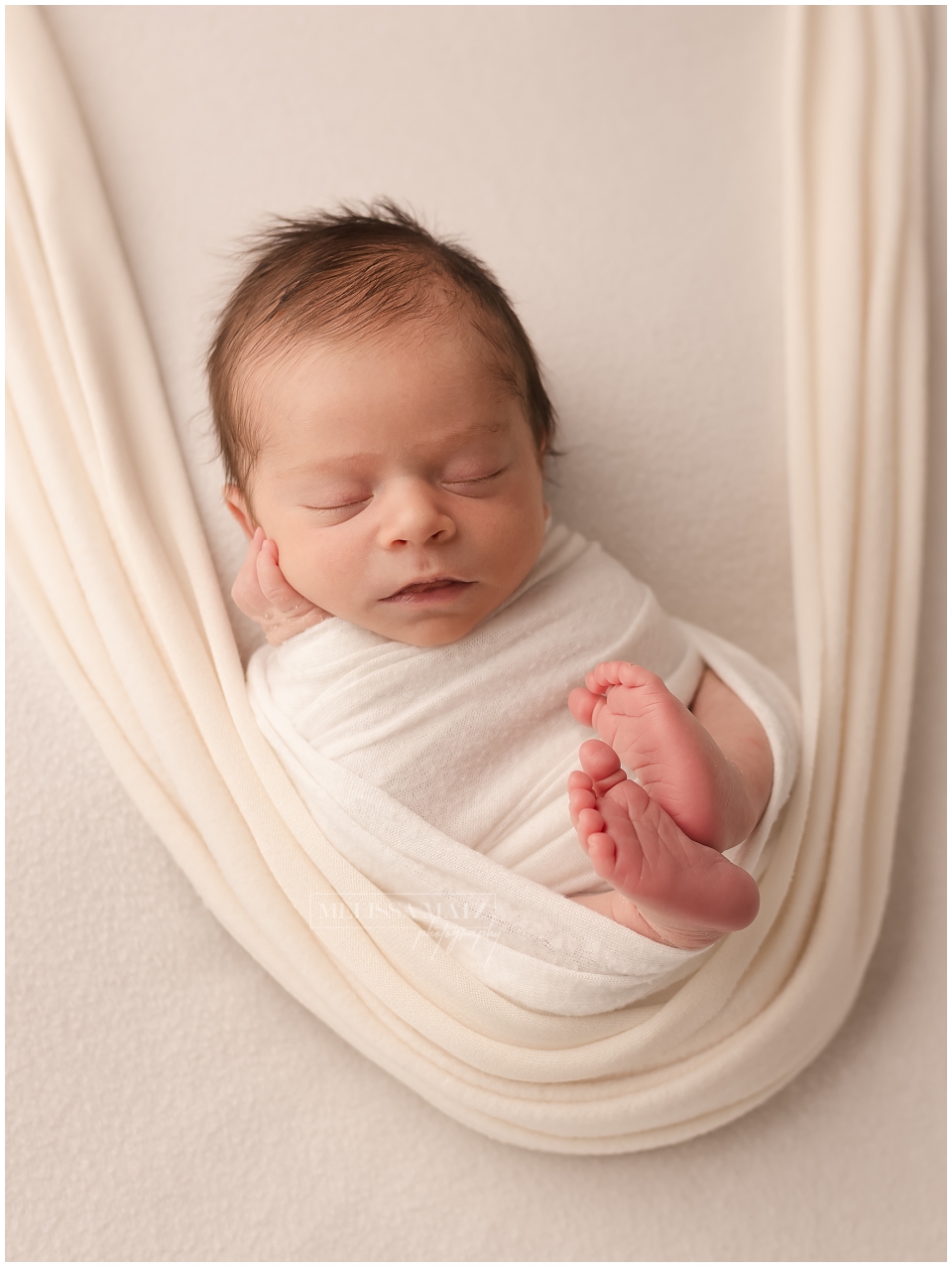 newborn swaddled in white wrap forward facing portrait metro detroit