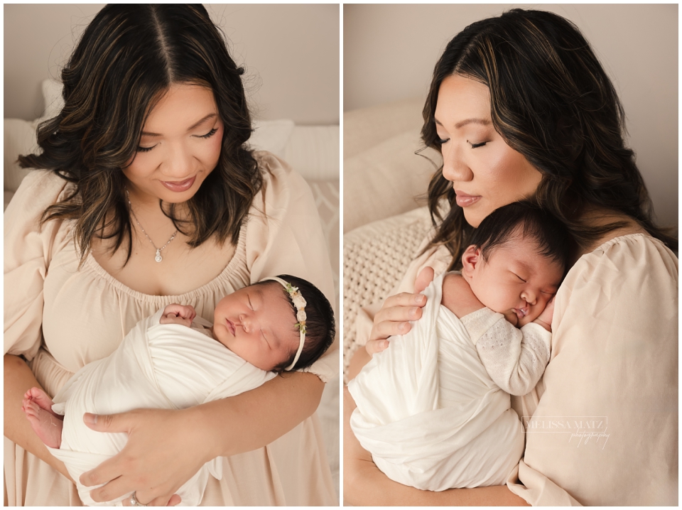 Mother cuddling their newborn baby during family portrait