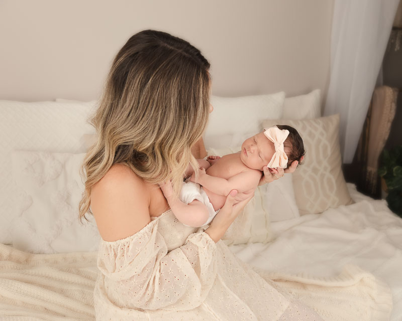 Quiet tender moment between mother and newborn baby photographed at a Shelby Township MI newborn photography studio during the first two weeks of motherhood