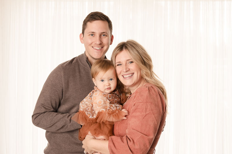 Parents and baby in cream and terra cotta coordinated outfits at Melissa Matz Photography in Shelby Township