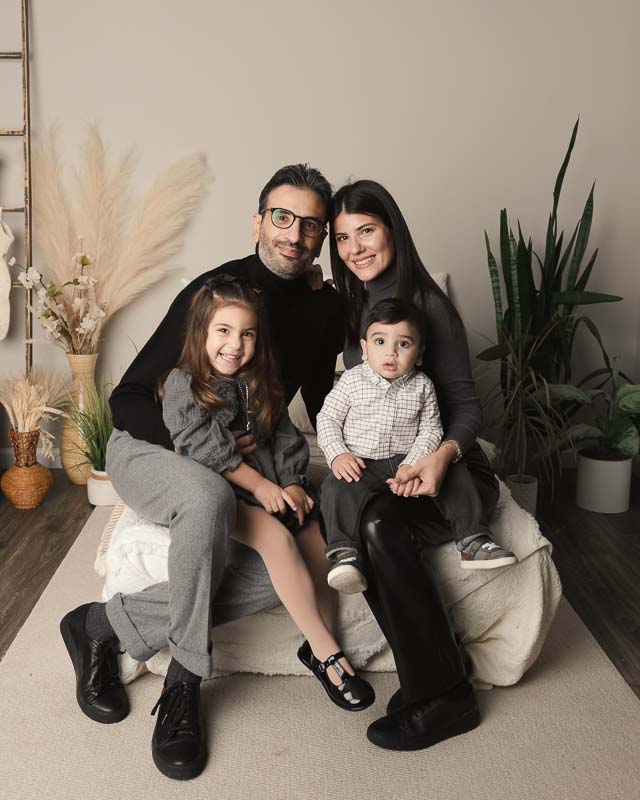 Family in gray coordinated outfits during a one year session at Melissa Matz Photography studio