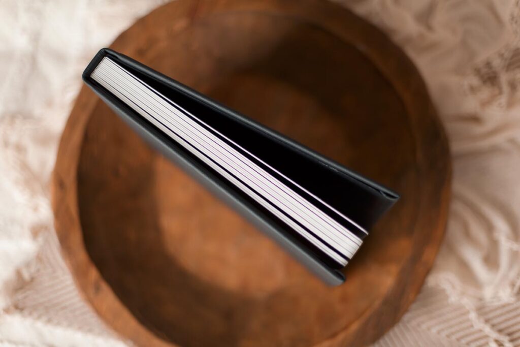Close up of flush mount newborn photo album pages showing lay flat binding quality at Melissa Matz Photography