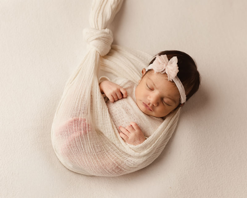 Newborn baby swaddled in hammock wrap pose — Shelby Township newborn photographer