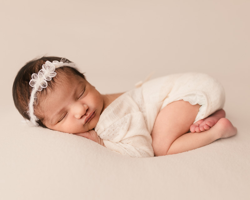 Newborn baby girl in white romper sleeping on side — Shelby Township newborn session