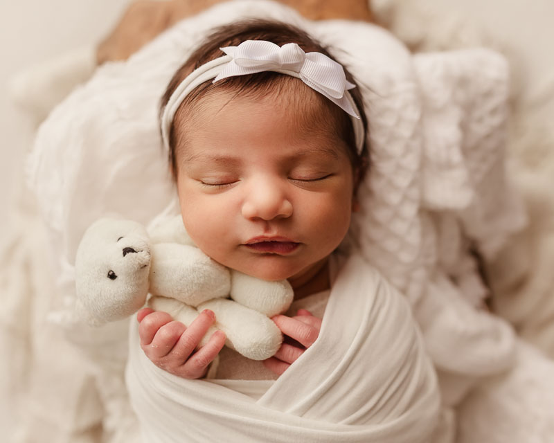 Newborn baby girl in cream holding teddy bear — Metro Detroit newborn session