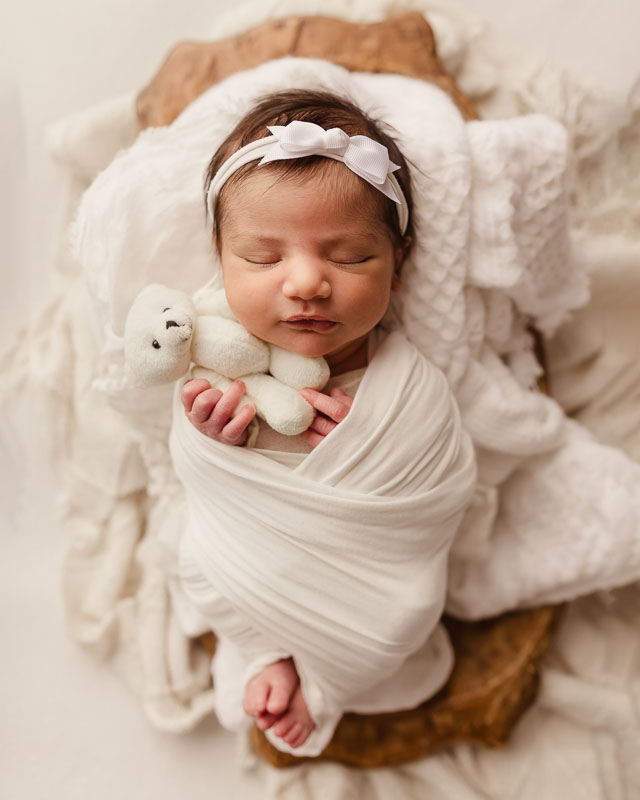 Wrapped newborn baby girl with teddy bear in wooden bowl — Shelby Township newborn photographer