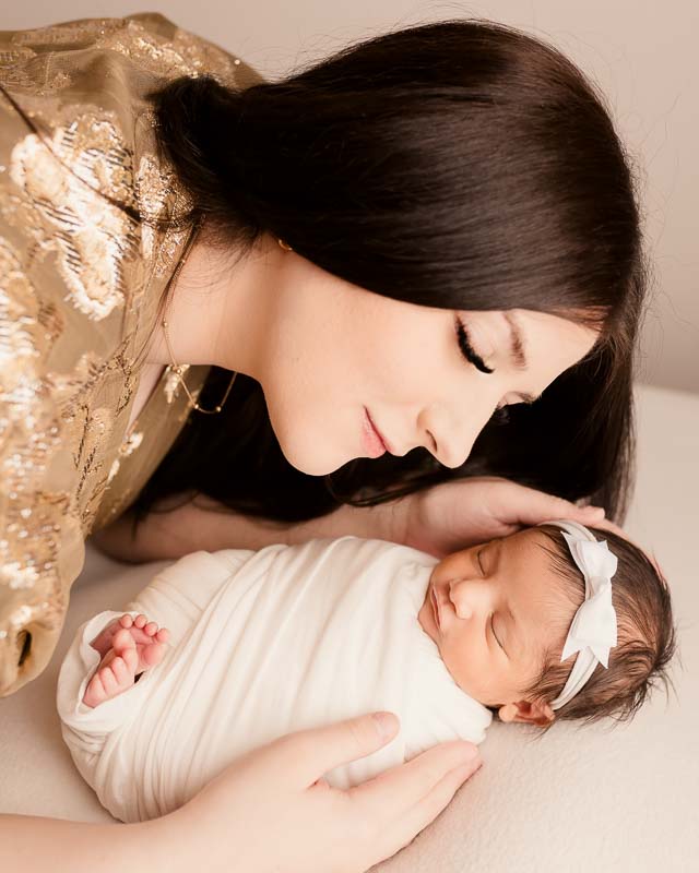 Mom snuggling wrapped newborn baby — Metro Detroit newborn photographer