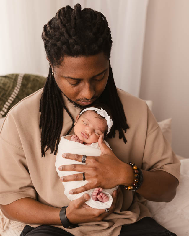 Dad cradling sleeping newborn baby — Shelby Township family newborn photography