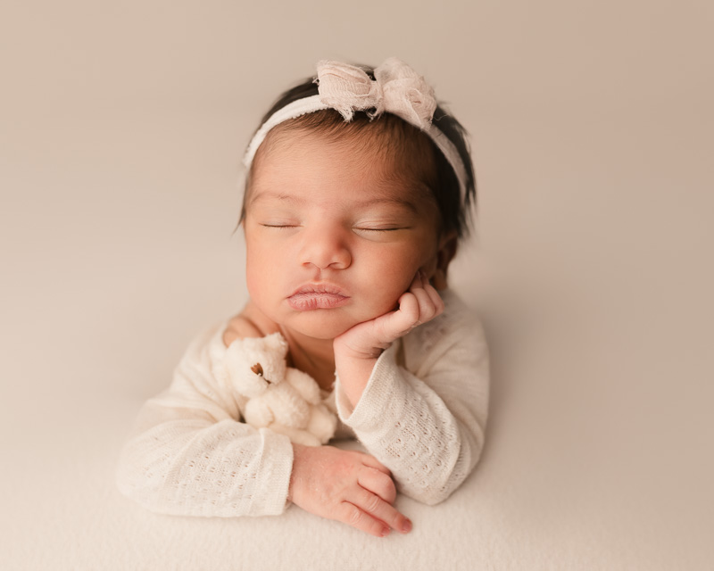 Newborn baby in froggy pose on neutral backdrop — Metro Detroit newborn photography studio