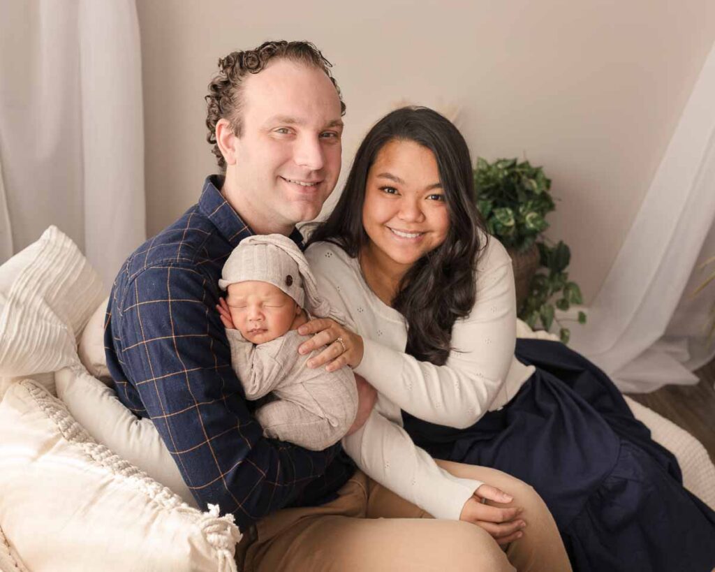 family with newborn baby during posed studio session Metro Detroit newborn photographer