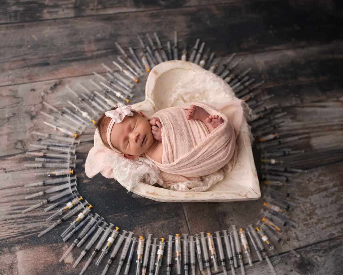 newborn baby with IVF needles during newborn session at Melissa Matz Photography Metro Detroit